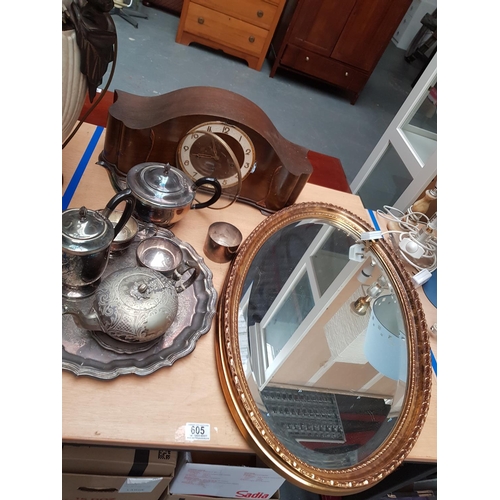 605 - A wooden mantle clock, silver plated items and a bevel edge gilt framed mirror