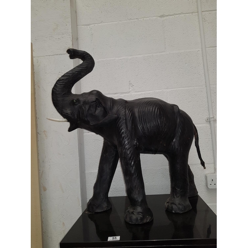 55 - A large leather figure of an elephant with simulated ivory tusks (720mm to the tip of the trunk)