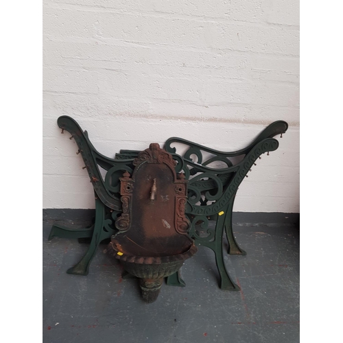 759 - Cast iron bench ends, table ends and a cast iron garden water feature