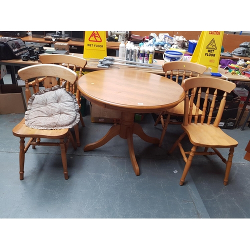 793 - A pine circular dining table and four chairs