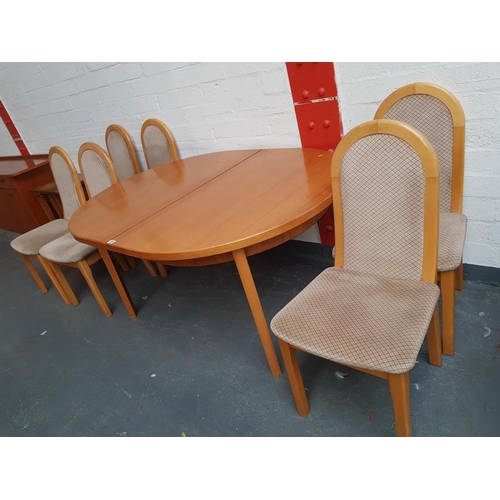 304 - An oval teak extending table and six chairs