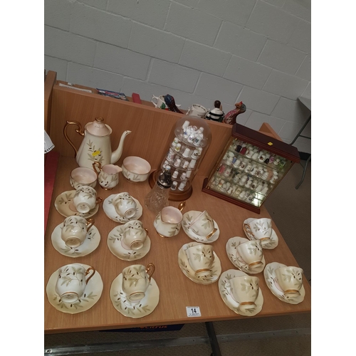 14 - A quantity of china thimbles in display stands and a Royal Albert coffee set