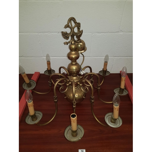 50 - A large Flemish brass eight arm chandelier with Eagle to top
