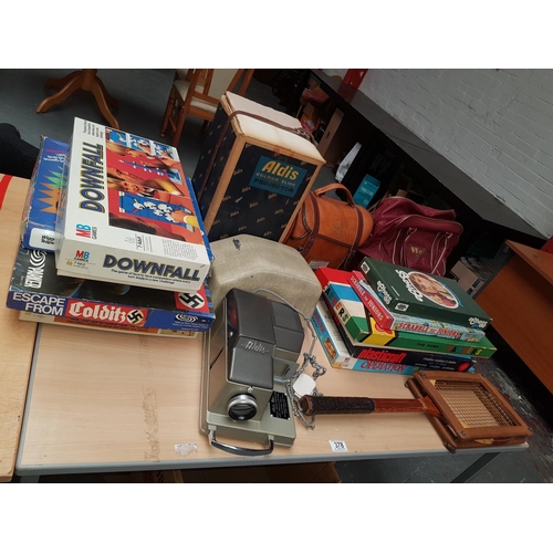 378 - A set of Coswold bowls, boxed Aldis colour projector, boxed vintage games including Escape from Cold... 