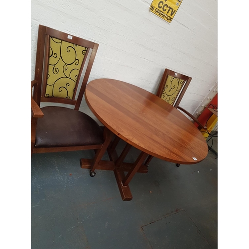510 - A circular dining table and two chairs
