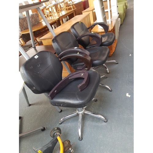 530 - Three black barber chairs