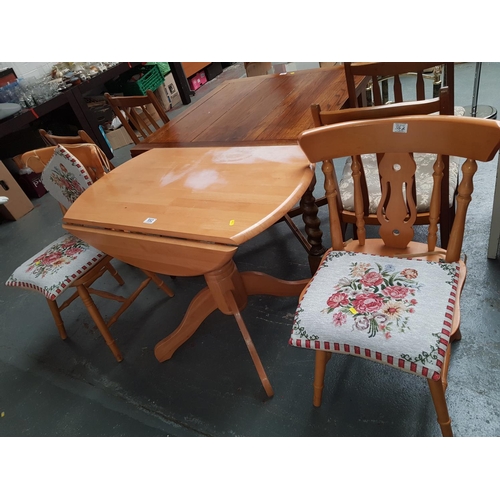 552 - A pine drop leaf dining table and two chairs