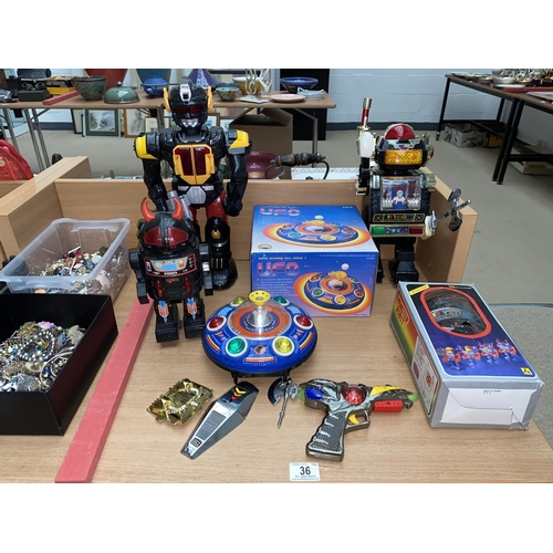 36 - Four vintage toy robots and one UFO vehicle