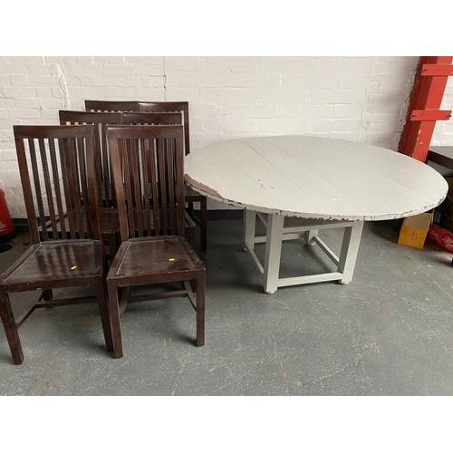 317 - A large painted circular dining table and six chairs