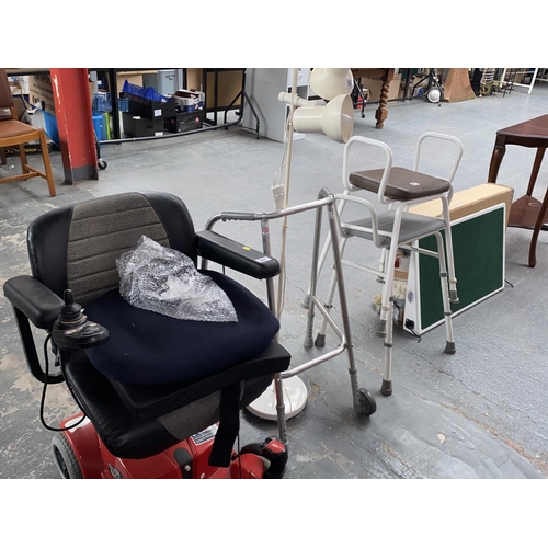 557 - A quantity of mobility aids including electric chair, seats etc.