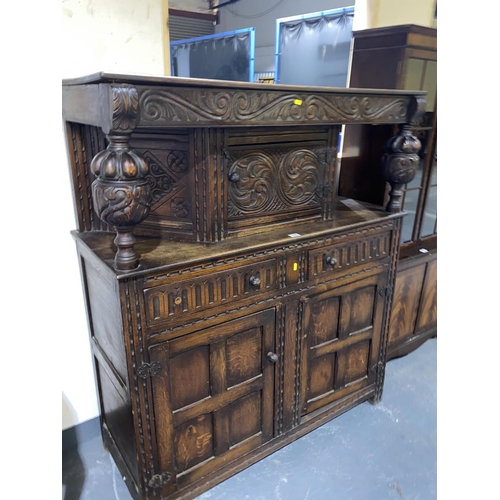 110 - A heavily carved oak court cupboard