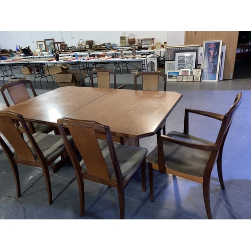 119 - A  teak extending dining table and six chairs