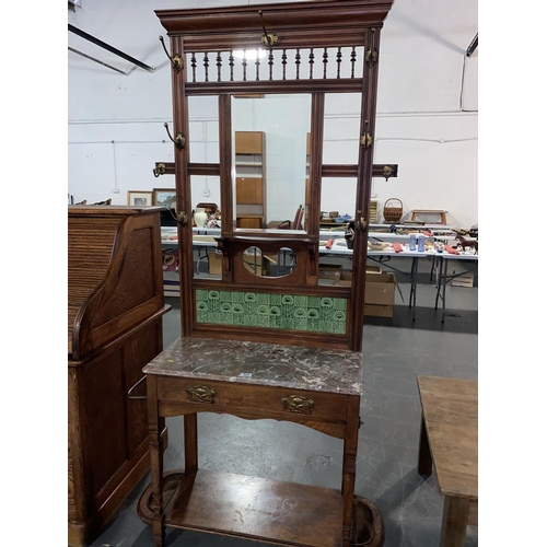 121 - A mahogany hall stand with marble top and tiled and mirrored back