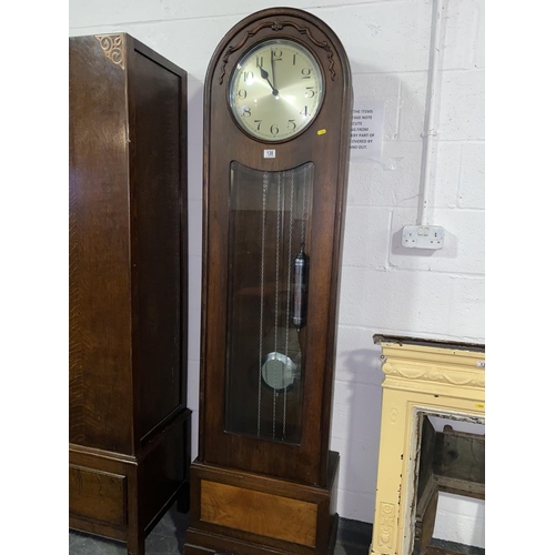 138 - An oak cased 1930s grandfather clock with twin chromed weights and silvered dial