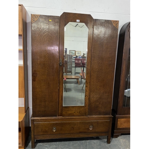 139 - An oak wardrobe with mirrored door and single drawer