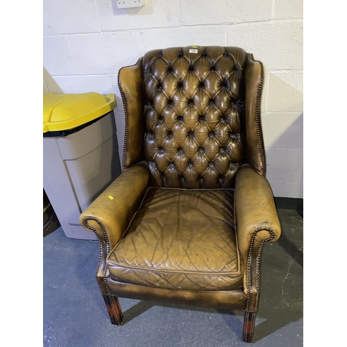 143 - A light brown leather wing back chesterfield chair