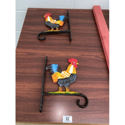 62 - Two cast iron cockerel basket hangers