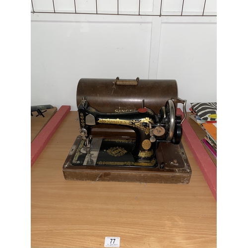 77 - A hand crank Singer sewing machine in wooden case with key