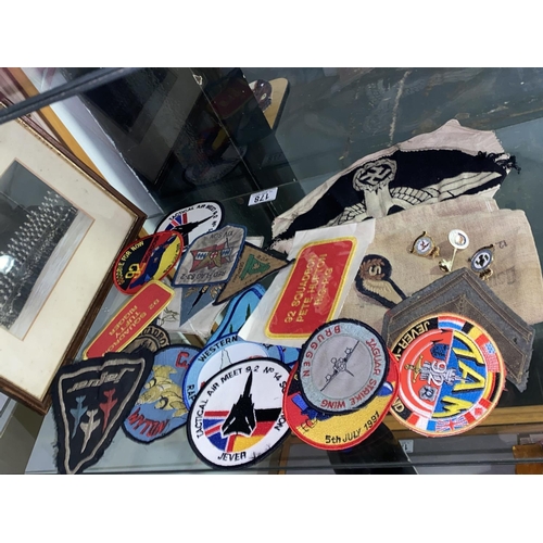 178 - A framed RAF cap badge and squadron plus loose squadron badges, enamel badges, German money bag etc.