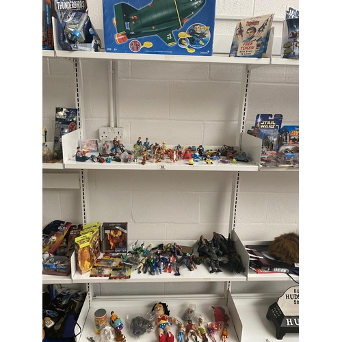 66 - Mixed TV and film related figures including Thunderbirds, Power Rangers etc - 4 shelves
