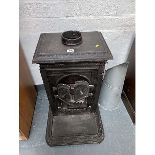 306 - A cast iron fireplace and a metal coal scuttle
