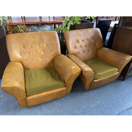 331 - A pair of orange leather armchairs