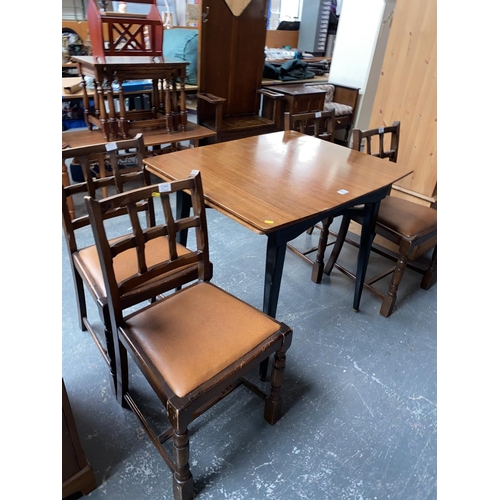 377 - A draw leaf dining table and four chairs