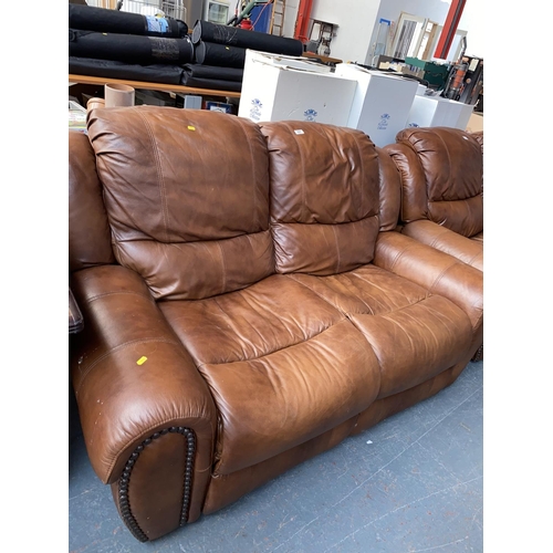 397 - A brown leather two seater sofa