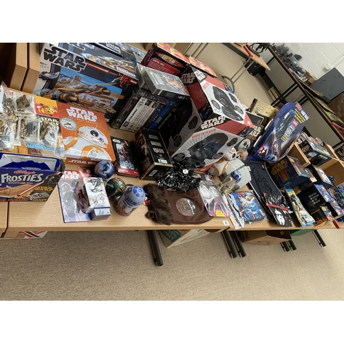 42 - A large collection of Star Wars related items including books,videos, podracer,Pez sweets etc.