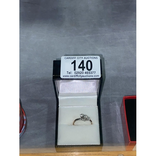 140 - An 18k, three diamond engagement ring ( 1 x .10 and 2 .07 diamonds) total weight 2.7 grams SIZE O