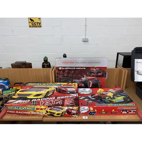 10 - A Scalextric boxed pro racing series, Simpsons micro Scalextric and a Vodaphone McLaren set