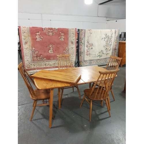 98 - A Ercol extending dining table and four chairs with two leaves