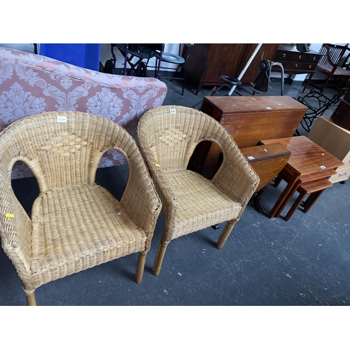 538 - Two wicker chairs, nest of tables and two drop leaf tables