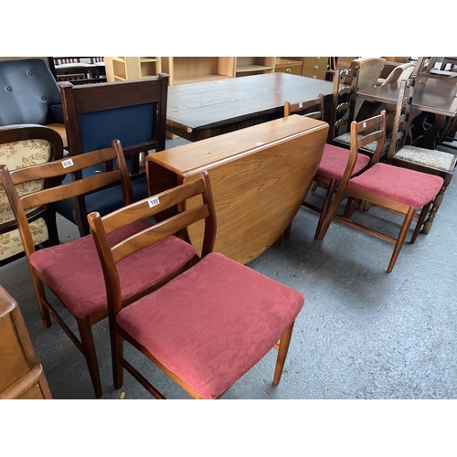 555 - A teak drop leaf dining table and four chairs