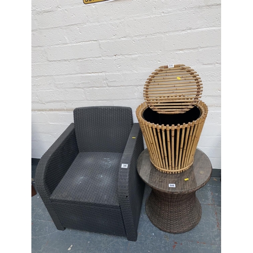 306 - A rattan armchair and a rattan round table and a bamboo beer cooler