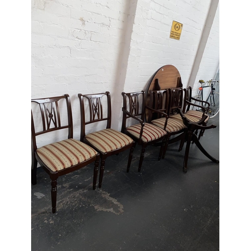310 - A mahogany extending dining table and six chairs