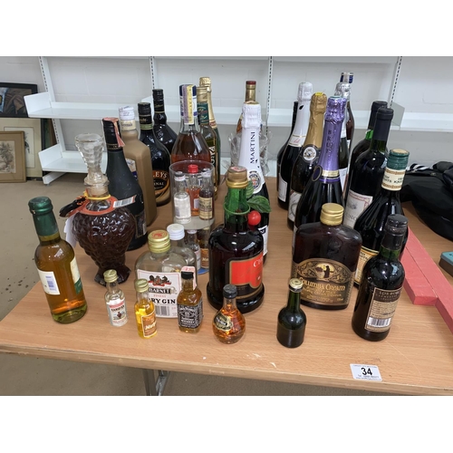 34 - A collection of alcohol including whisky, champagne, liquors etc.
