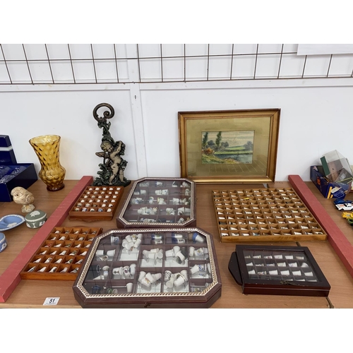 51 - Collectable thimbles, display cases, cherub cast iron door stop and an early framed painting of rive... 