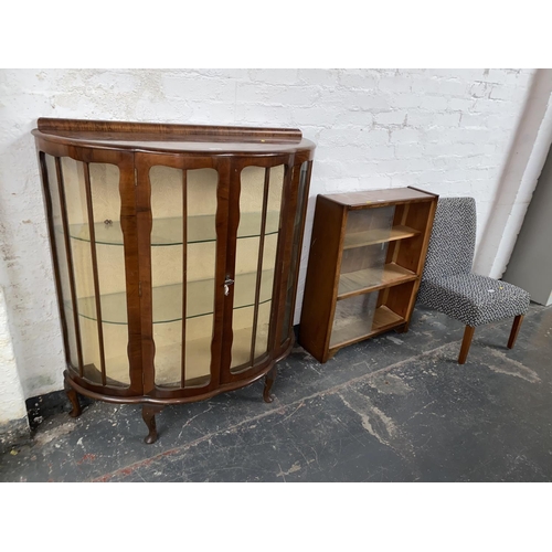 709 - A glass fronted display cabinet, a glass fronted bookcase and a chair