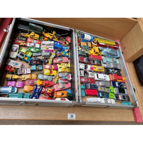 30 - A collection of playworn vehicles in case including Corgi, Matchbox etc.
