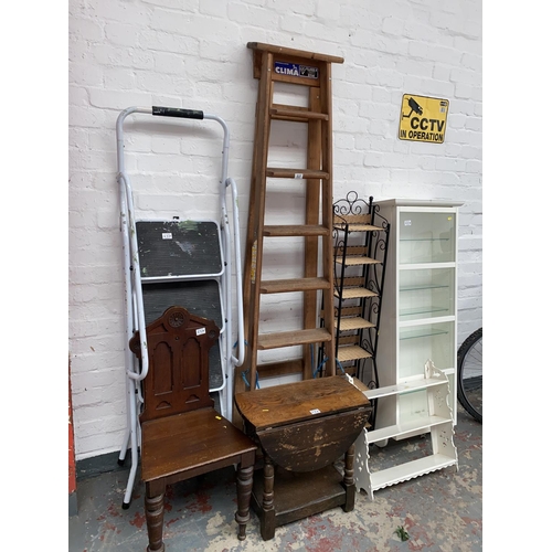 537 - A quantity of mixed items to include ladders, display cabinet etc.