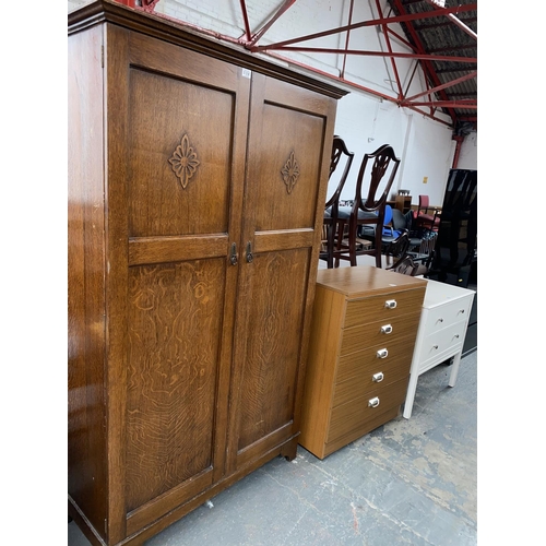 556 - An oak wardrobe and two chest of drawers
