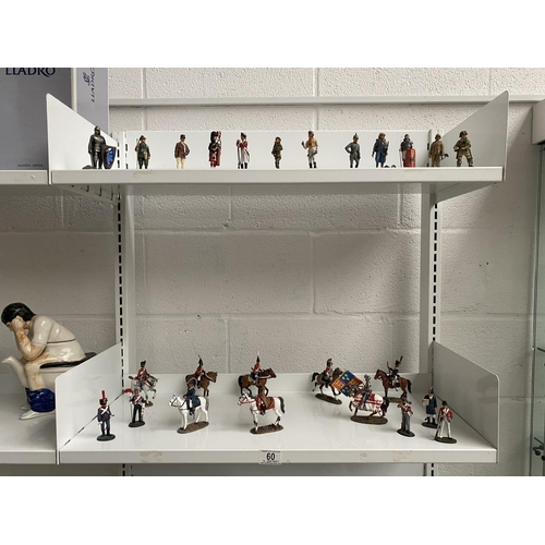 60 - A large collection of Del Prado metal soldiers and soldiers on horseback - two shelves