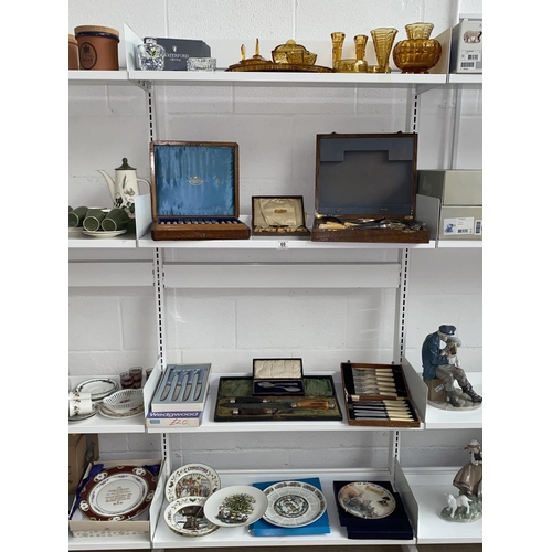 69 - A collection of mixed glass and china, boxed cutlery sets including Wedgwood etc- 4 shelves