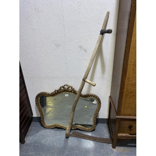 116 - An antique scythe and a gilt framed bevelled edged mirror