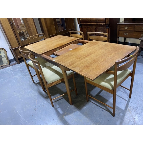 124 - A mid century McIntosh and Co Ltd draw leaf dining table and six teak dining chairs including two ca... 