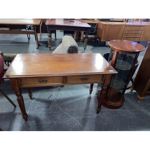 134 - A mahogany two drawer desk and a mahogany circular display cabinet