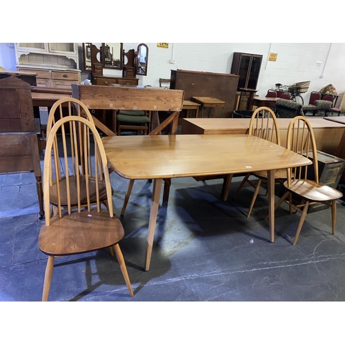 150 - An Ercol blonde dining table and four dining chairs