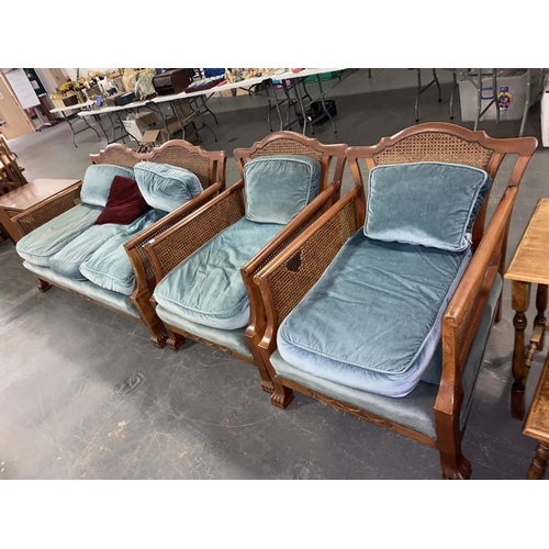 164 - A Bergere lounge suite consisting of a three seater sofa and two matching armchairs