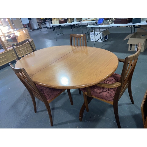 166 - A teak oval G Plan dining table and four chairs